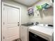 Laundry room with washer, dryer, door and shelving at 480 Nw 55Th Ave, Ocala, FL 34482