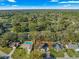 An aerial view showing the house, pool, manicured lawn, and surrounding treed neighborhood at 5115 Se 20Th St, Ocala, FL 34480