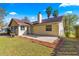 Backyard view of the house, featuring a patio, palm trees, and a chimney at 5115 Se 20Th St, Ocala, FL 34480