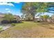 The large backyard features mature trees and a fire pit at 5115 Se 20Th St, Ocala, FL 34480