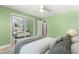 Bright bedroom featuring hardwood floors, closet, ceiling fan, and natural light at 5115 Se 20Th St, Ocala, FL 34480