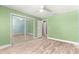 Bright bedroom featuring hardwood floors, closet, ceiling fan, and natural light at 5115 Se 20Th St, Ocala, FL 34480