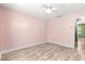 This light and airy bedroom features hardwood floors and neutral paint at 5115 Se 20Th St, Ocala, FL 34480