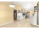 Spacious kitchen with stainless steel appliances, white cabinets, and sleek floating shelves at 5115 Se 20Th St, Ocala, FL 34480