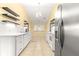 Bright kitchen featuring white cabinetry, stainless steel appliances, and floating shelves at 5115 Se 20Th St, Ocala, FL 34480