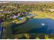 Beautiful aerial view of community pool, tennis courts, and lake at 5464 Sw 41St St, Ocala, FL 34474