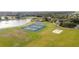 Overhead shot showcasing tennis courts and a lake in a green setting at 5464 Sw 41St St, Ocala, FL 34474