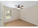 Bright bedroom features a ceiling fan and a window providing natural light at 5464 Sw 41St St, Ocala, FL 34474