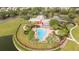 Aerial view of a community pool and clubhouse with landscaped grounds and colorful architecture at 5464 Sw 41St St, Ocala, FL 34474