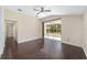 Open living room with a ceiling fan, hardwood floors, sliding glass doors to lanai, and neutral colored walls at 5464 Sw 41St St, Ocala, FL 34474