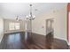 Spacious living room with dark wood floors, ceiling fan, and a chandelier at 5464 Sw 41St St, Ocala, FL 34474