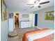 The bedroom features a ceiling fan, dresser, paintings, and a door to the walk-in closet at 5490 Se Highway 42, Summerfield, FL 34491