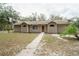 Charming single-story home with a well-manicured front yard and walkway leading to the front door at 5490 Se Highway 42, Summerfield, FL 34491