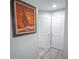 Hallway view featuring a beautiful painting of a sailboat and two white doors at 5490 Se Highway 42, Summerfield, FL 34491