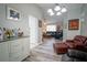 Bright living room showcasing wood floors, a large sofa set, and an area rug at 5490 Se Highway 42, Summerfield, FL 34491