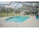 Backyard screened-in pool with a sunbathing deck and view of the backyard at 5490 Se Highway 42, Summerfield, FL 34491