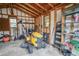 Organized shed interior with a riding lawnmower, shelving units and various yard tools at 5490 Se Highway 42, Summerfield, FL 34491