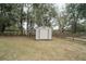 Outdoor shot of the storage shed with white walls and a brown trim and a single door at 5490 Se Highway 42, Summerfield, FL 34491