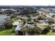 Aerial view of a quiet neighborhood showing a residential property near a lake and a road with light traffic at 5812 Luzon Pl, Orlando, FL 32839