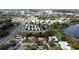 Aerial view of a residential area showcasing a home with a well-maintained yard and surrounding mature trees and local street at 5812 Luzon Pl, Orlando, FL 32839