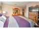 A bright bedroom featuring a dresser and large bed at 5812 Luzon Pl, Orlando, FL 32839