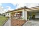 Inviting front porch with porch swing, chairs, and a side carport featuring a large potted plant and a pathway with lighting at 5812 Luzon Pl, Orlando, FL 32839