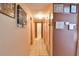 A well-lit hallway with framed pictures and tile flooring at 5812 Luzon Pl, Orlando, FL 32839