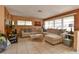 Inviting living room featuring tile flooring, neutral-toned sofas, large windows with blinds, and contemporary decor for a cozy feel at 5812 Luzon Pl, Orlando, FL 32839