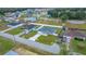 Aerial view of a home with a well-manicured lawn and a long driveway at 6 Dogwood Loop Ave, Ocala, FL 34472