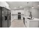 Contemporary kitchen featuring white cabinets, black stainless steel appliances, and a center island at 6 Dogwood Loop Ave, Ocala, FL 34472