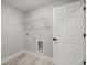 Bright laundry room with washer/dryer hookups and a wire shelf for storage at 6 Dogwood Loop Ave, Ocala, FL 34472