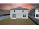 Backyard view of a two-story home with a sliding glass door and white fence at 6320 Sw 74Th Terrace Rd, Ocala, FL 34474