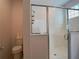 Bathroom featuring toilet and a shower with sliding glass doors at 6320 Sw 74Th Terrace Rd, Ocala, FL 34474