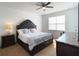 Bedroom featuring a ceiling fan, a window with blinds and a well decorated bed with bedside table at 6320 Sw 74Th Terrace Rd, Ocala, FL 34474