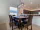 Dining area with a dark wood table, leather chairs, modern light fixture, and a view into the kitchen at 6320 Sw 74Th Terrace Rd, Ocala, FL 34474