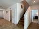 Hallway featuring neutral colors, tile floors, and stairway at 6320 Sw 74Th Terrace Rd, Ocala, FL 34474