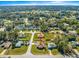 Aerial view of a home in a residential area, surrounded by trees at 7398 Hemlock Rd, Ocala, FL 34472