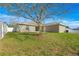 Backyard featuring a lawn, a privacy fence, and an exterior view of the home at 7398 Hemlock Rd, Ocala, FL 34472