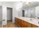 Bathroom featuring double sink vanity, large mirror, shower, and walk-in closet at 7398 Hemlock Rd, Ocala, FL 34472