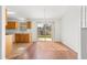 Bright dining room with hardwood floors, chandelier, and sliding door to the backyard at 7398 Hemlock Rd, Ocala, FL 34472