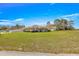 Exterior view of the house with green lawn at 7398 Hemlock Rd, Ocala, FL 34472