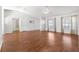 Bright living room with beautiful wood flooring, large windows, and ample natural light at 7398 Hemlock Rd, Ocala, FL 34472