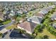 An elevated perspective of the home highlighting the roof, mature landscaping, and neighborhood layout at 805 Pickett Rd, The Villages, FL 32163