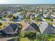 A bird's-eye view of a residential area showcasing home placement and surrounding lush landscaping at 805 Pickett Rd, The Villages, FL 32163