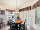 Cozy breakfast nook with a round table, chandelier, and window with patterned valances at 805 Pickett Rd, The Villages, FL 32163