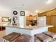 Kitchen featuring a breakfast bar, stainless appliances, and wood cabinetry at 805 Pickett Rd, The Villages, FL 32163