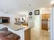 Bright kitchen featuring stainless steel appliances, tile floors, breakfast bar, and an adjacent laundry room at 805 Pickett Rd, The Villages, FL 32163