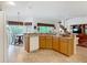 Kitchen featuring wood cabinets and open sight-lines to the living areas at 805 Pickett Rd, The Villages, FL 32163