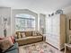 Cozy living room featuring a sofa, a large window with views, and a white cabinet for storage at 805 Pickett Rd, The Villages, FL 32163