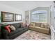 Bright living room featuring two sofas, a large window, and a floral-patterned rug at 805 Pickett Rd, The Villages, FL 32163